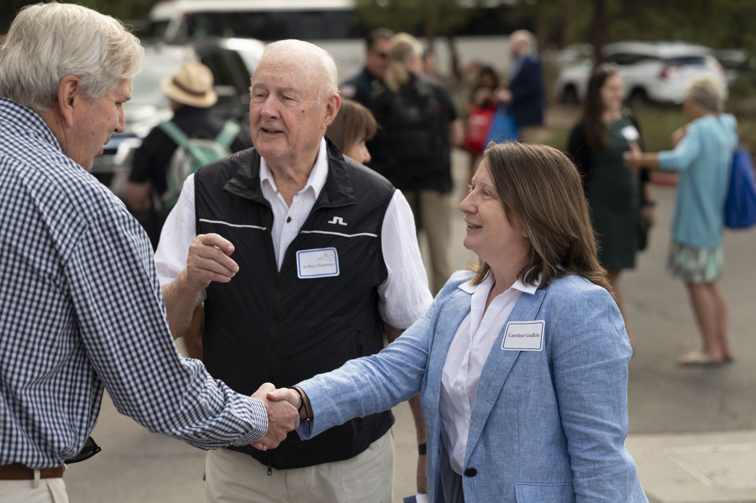 CWI Director Caroline Godkin shakes hands with other attendees at the Tahoe Summit in August.